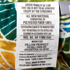 Pillow Perfect Omnia Lagoon cushion in patio setting on wicker loveseat showing stylish comfort
