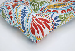 Pillow Perfect cushion placed on wicker chair showing outdoor styling benefit