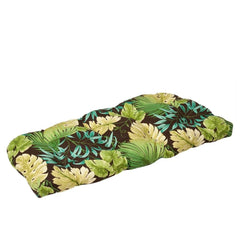 Pillow Perfect green Tropique Peridot front view on wicker loveseat showing vibrant tropical pattern and comfort