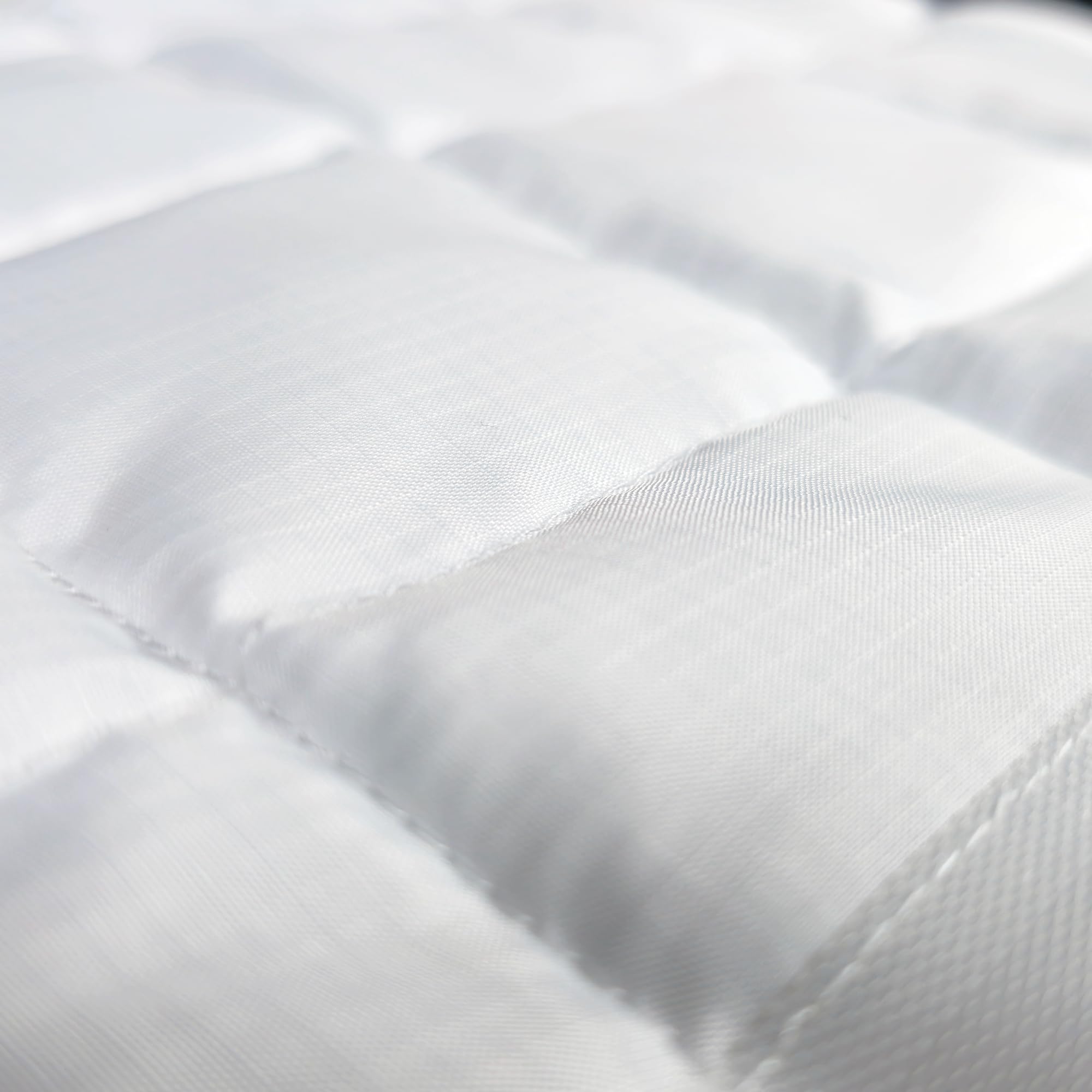 PillowWeights next to hand to show compact size and easy placement benefit