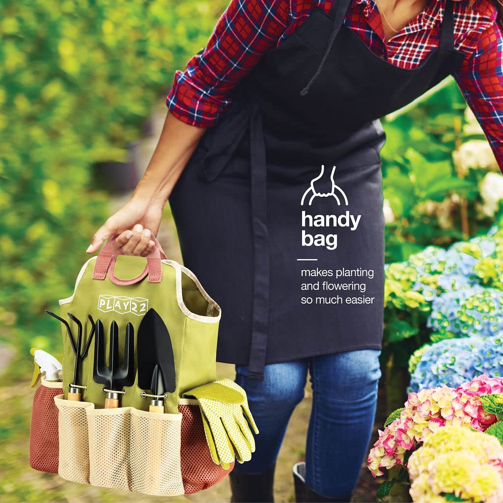 Play22 tools beside a hand for scale to show compact, ergonomic size