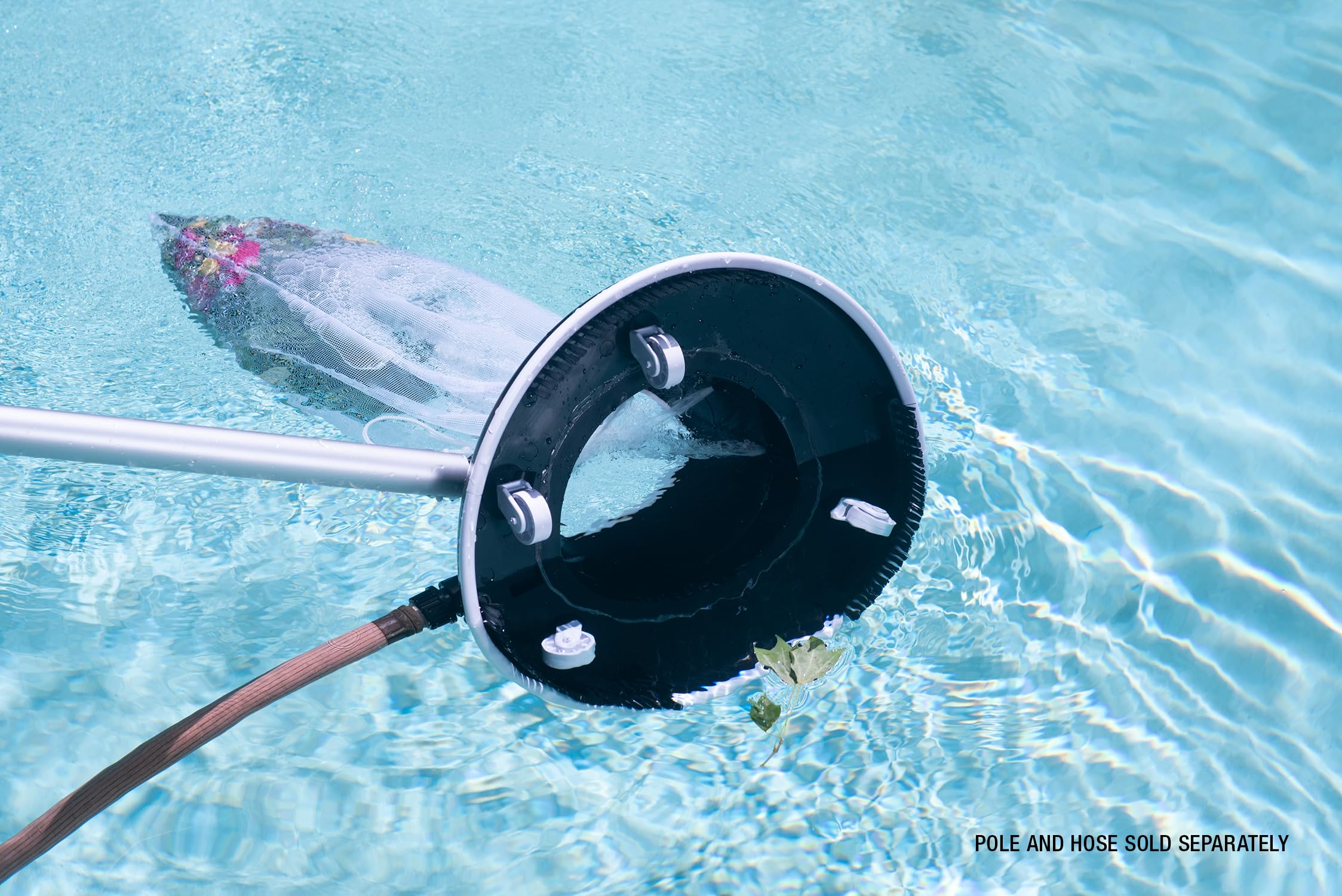 Poolmaster vacuum attached to hose in pool conveying fast leaf removal