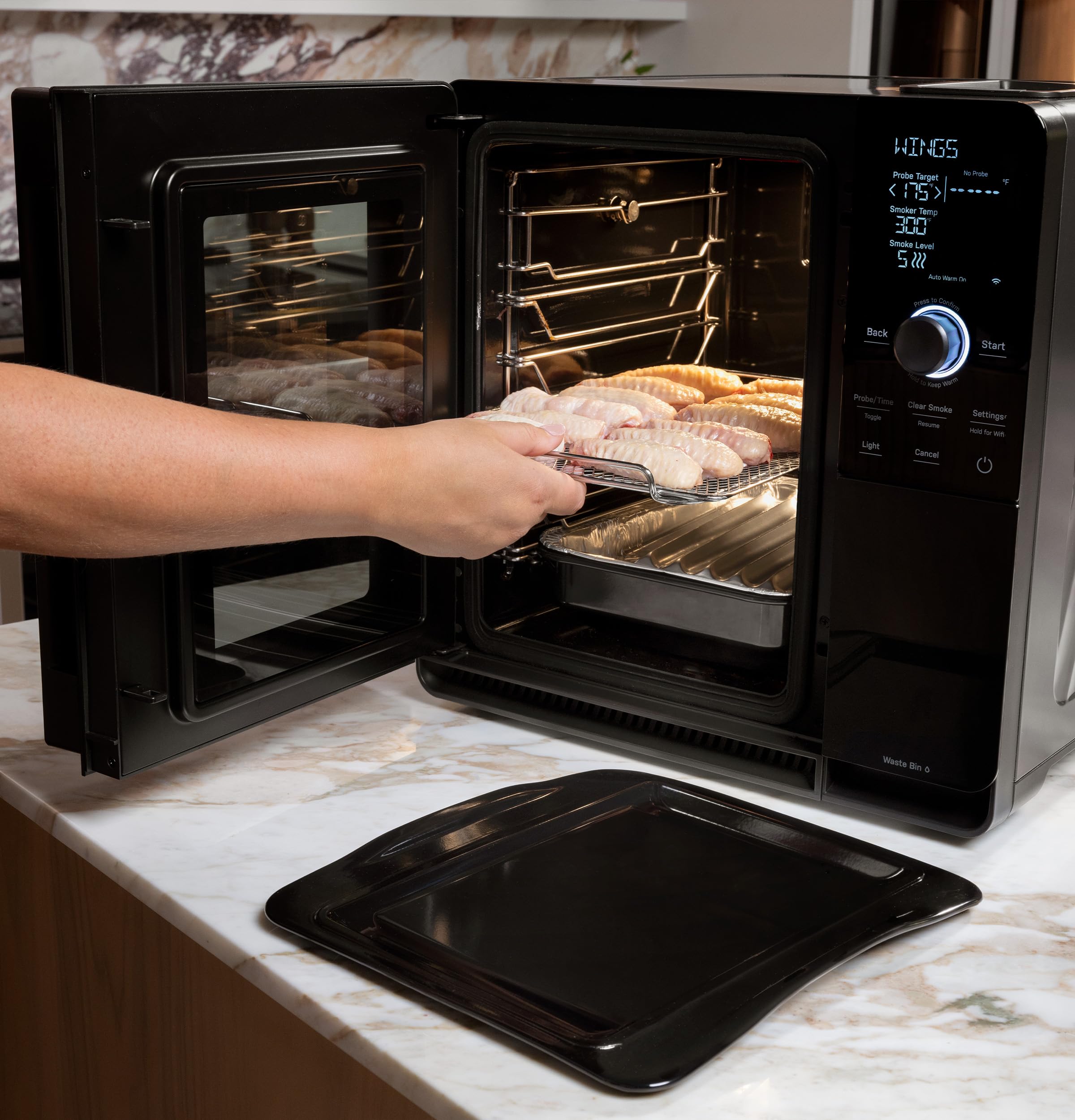 GE Profile prep tray installed in an indoor smoker holding seasoned food for mess-free cooking