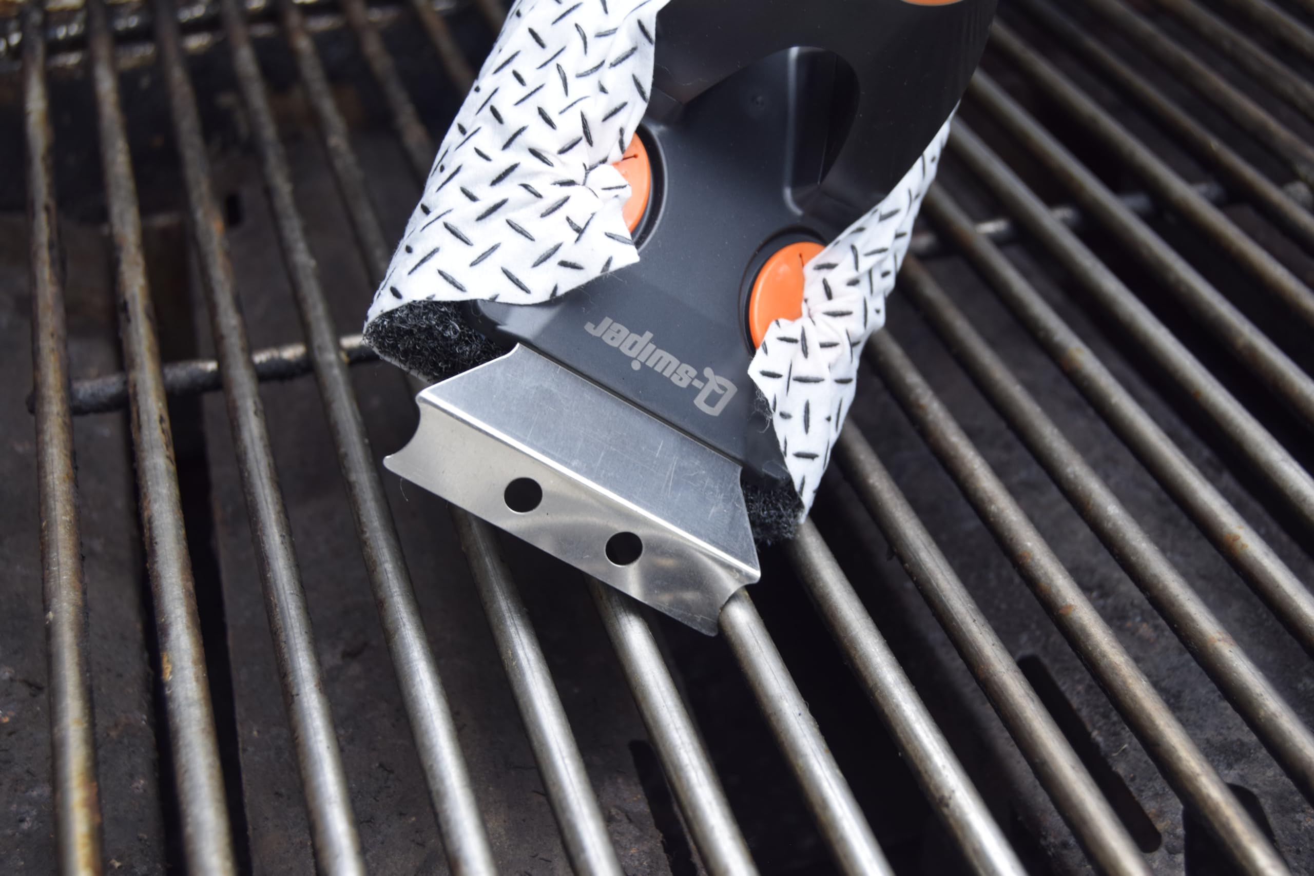 Proud Grill Company hanging Q-Swiper XL stored on a hook saving space in grill area