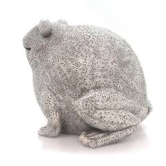 Pudgy Pals frog placed in a garden setting near potted plants, illustrating placement and curb appeal