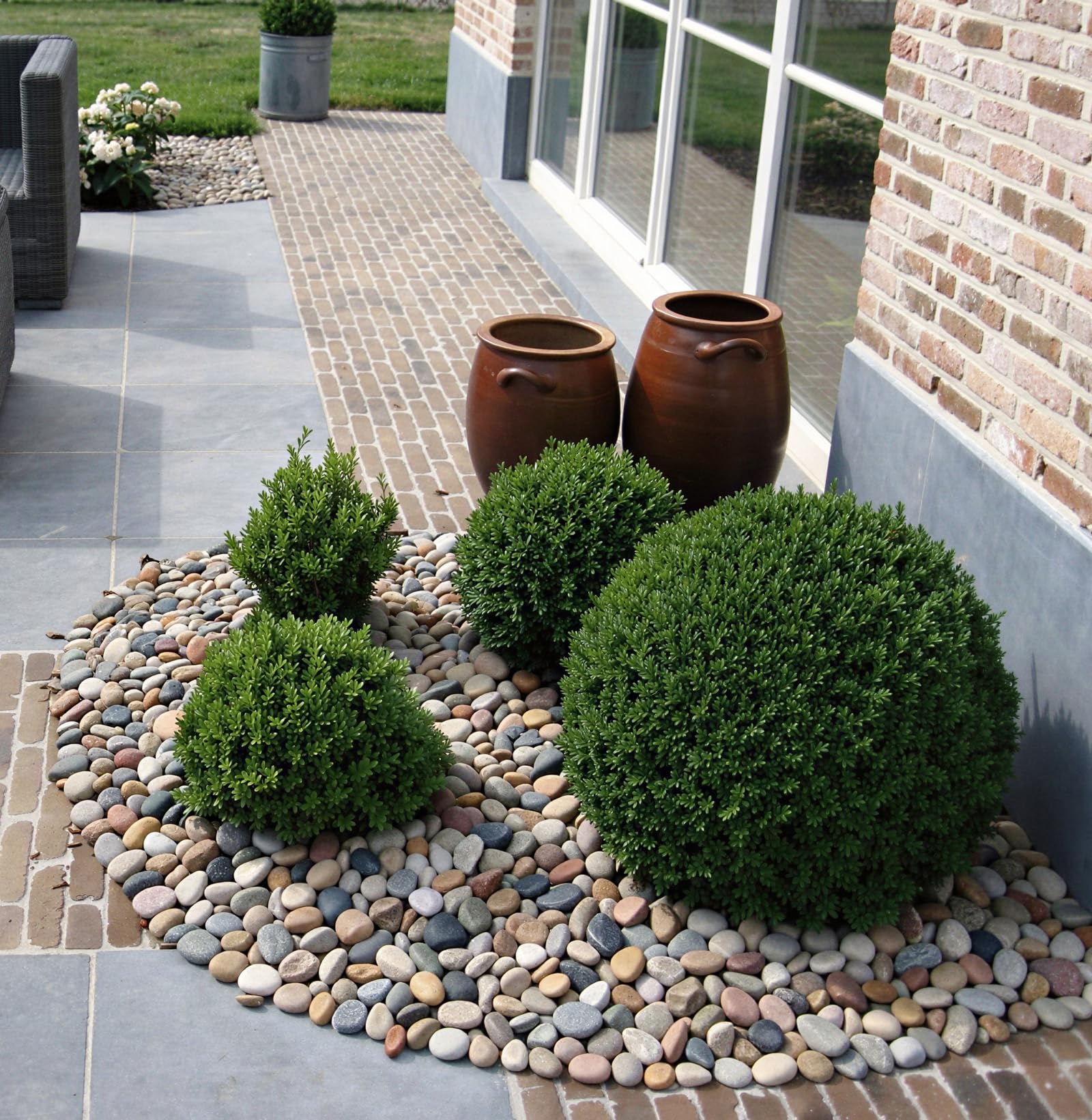 Pulovin in landscape bed around plants showing weed suppression and tidy edging benefit
