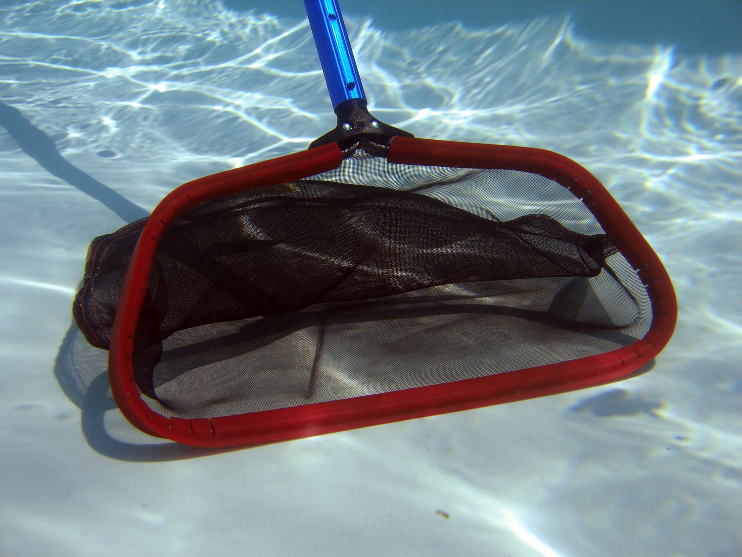 Purity Pool Red Baron in use skimming a pool, efficient debris collection benefit