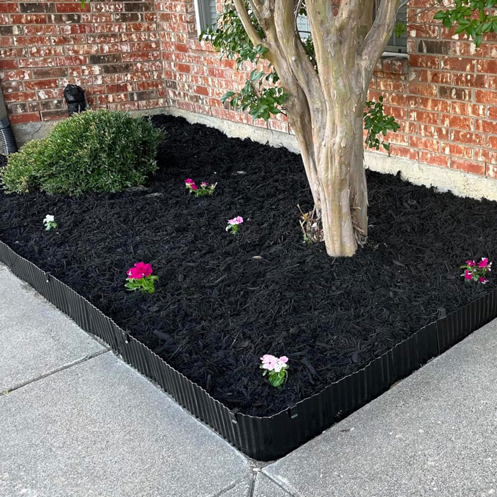 Quibbay black finish against mulch offering a subtle, tidy contrast