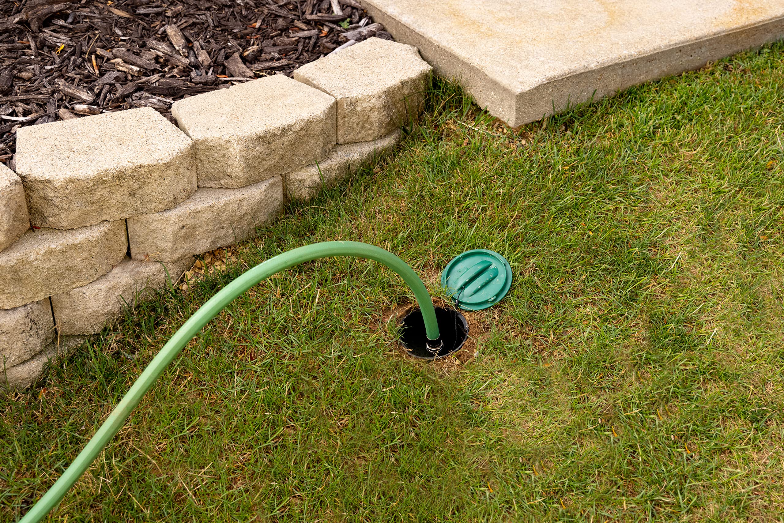 Rain Bird Click‑N‑Go connection atop buried housing for easy hose hookup