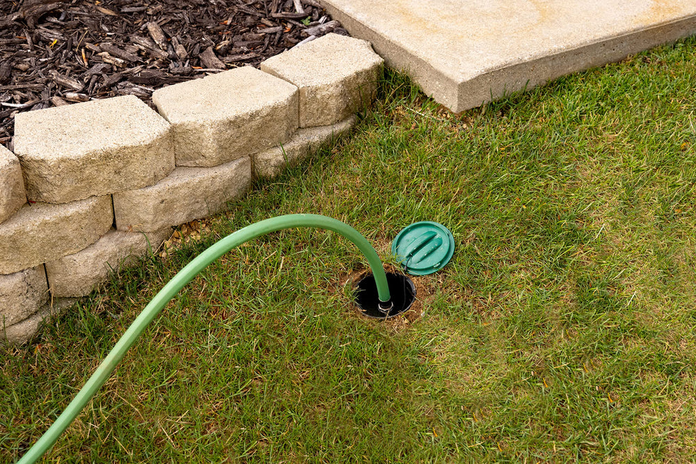 Rain Bird Click‑N‑Go connection atop buried housing for easy hose hookup