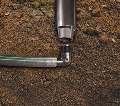 Rain Bird EZ Pipe beside tape measure showing 100-foot scale and coverage