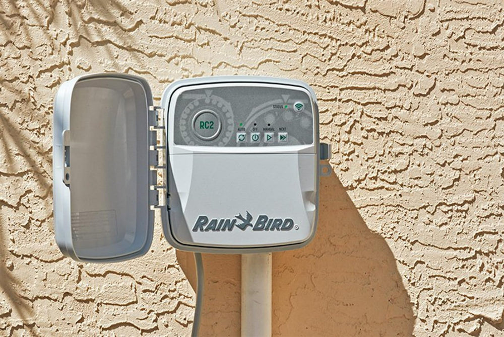 Rain Bird RC2 installed on exterior wall controlling yard irrigation effectively