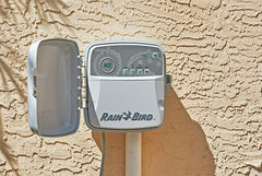 Rain Bird RC2 installed on exterior wall controlling yard irrigation effectively