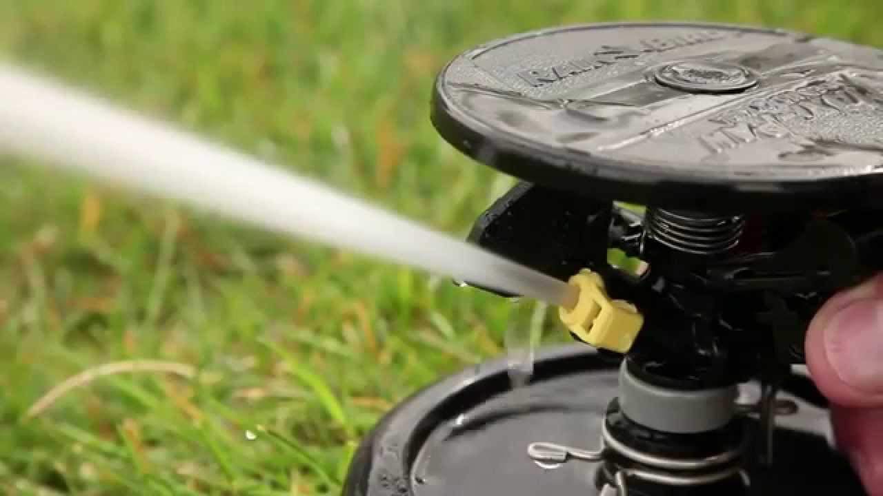 Rain Bird Maxi-Paw bottom and side inlet detail showing flexible pipe connection