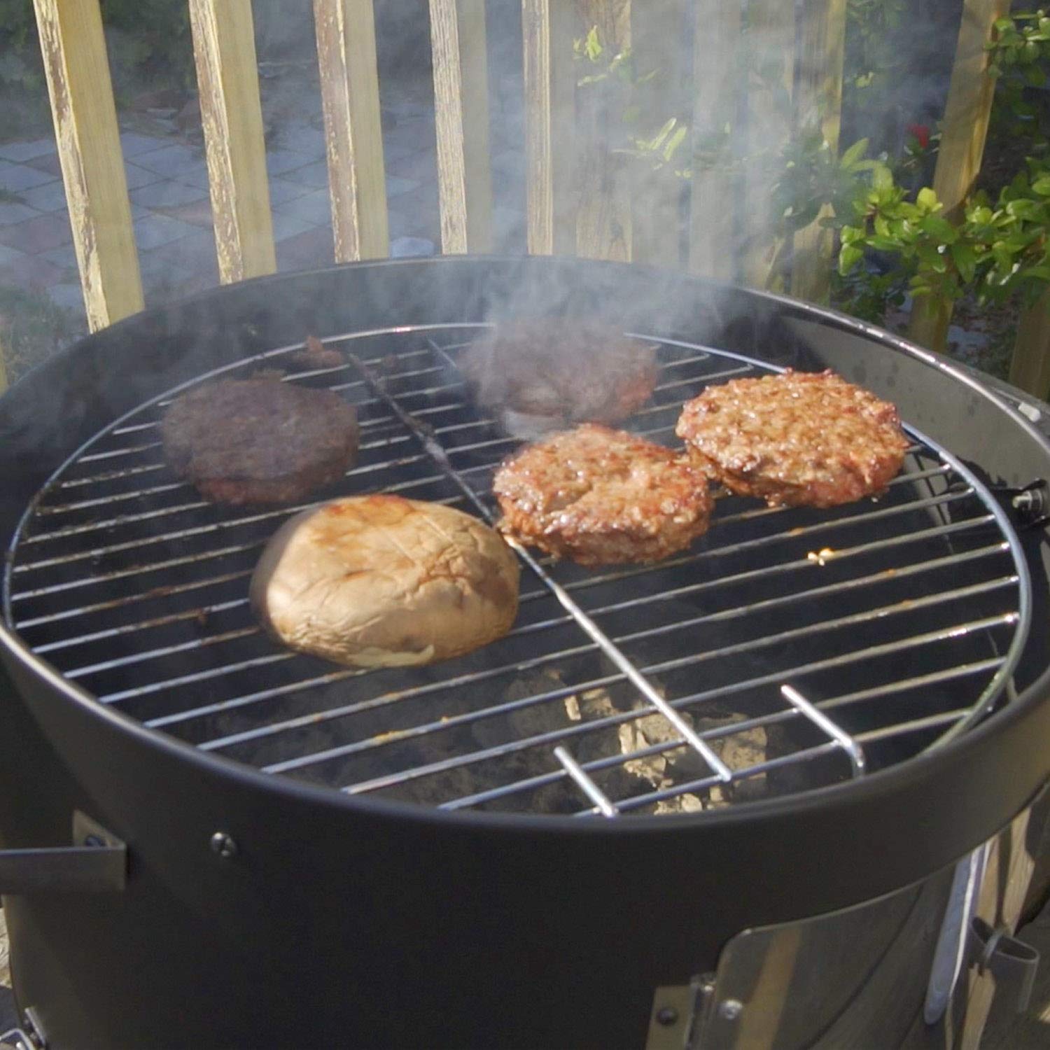Realcook interior showing two grates, crossbar and four hangers for multiple meats