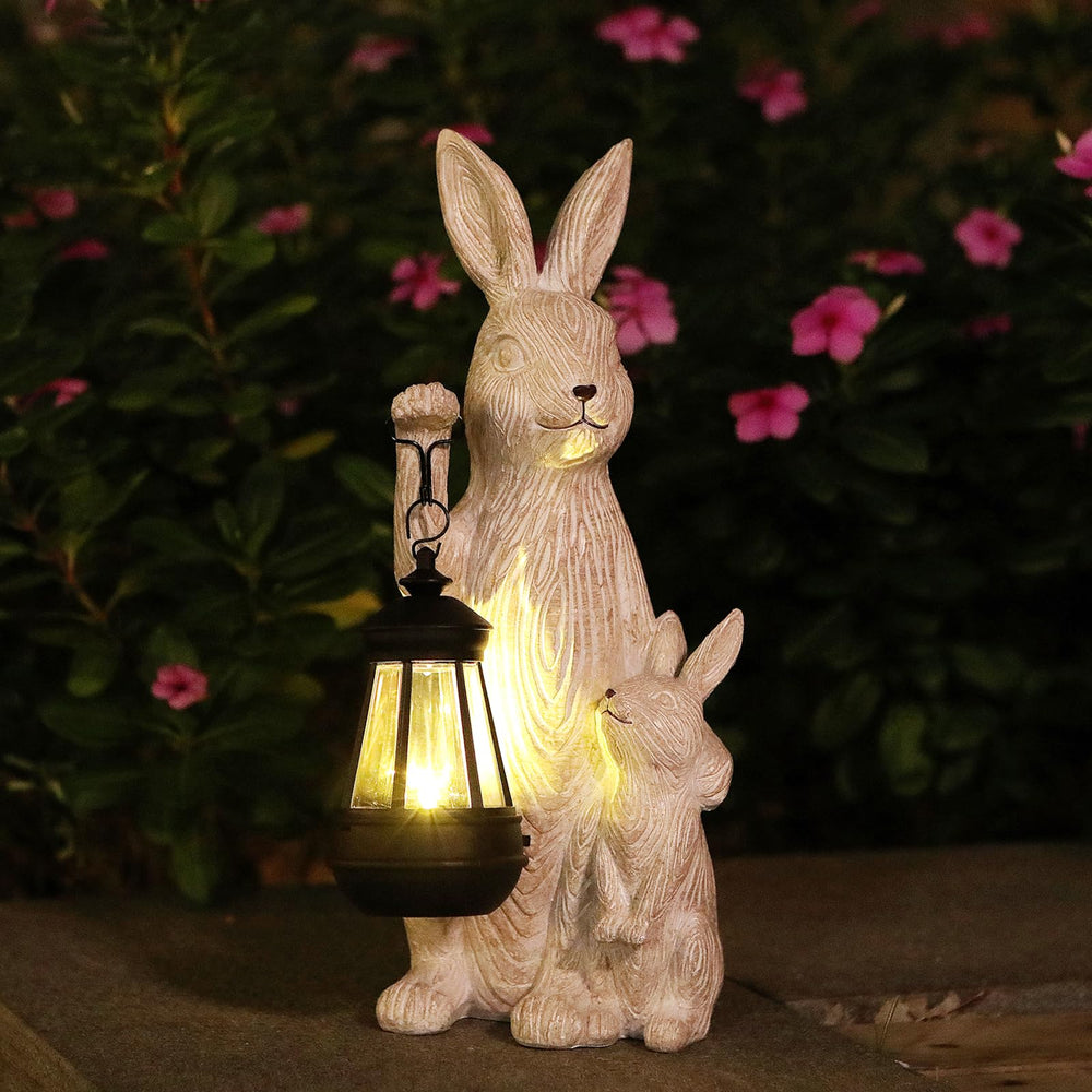 REYISO front view of rabbit statue showing decorative solar lantern and inviting look