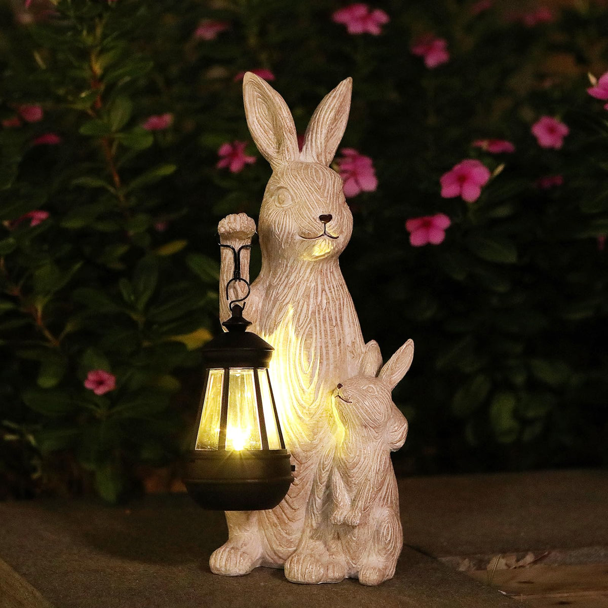 REYISO front view of rabbit statue showing decorative solar lantern and inviting look