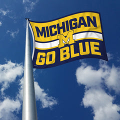 Rico Industries flag hung in a dorm room adding team spirit and vibrant decor to small spaces