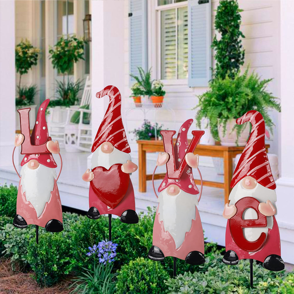 Ridota front view of four gnome stakes spelling LOVE, bright garden pop