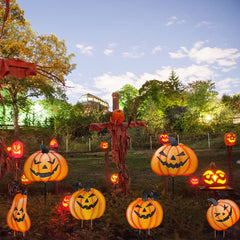 Ridota stacked tall pumpkin display beside walkway, creates a focal seasonal decoration