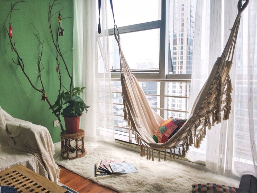 RISEON hammock suspended on porch, lifestyle scene showing comfortable lounging