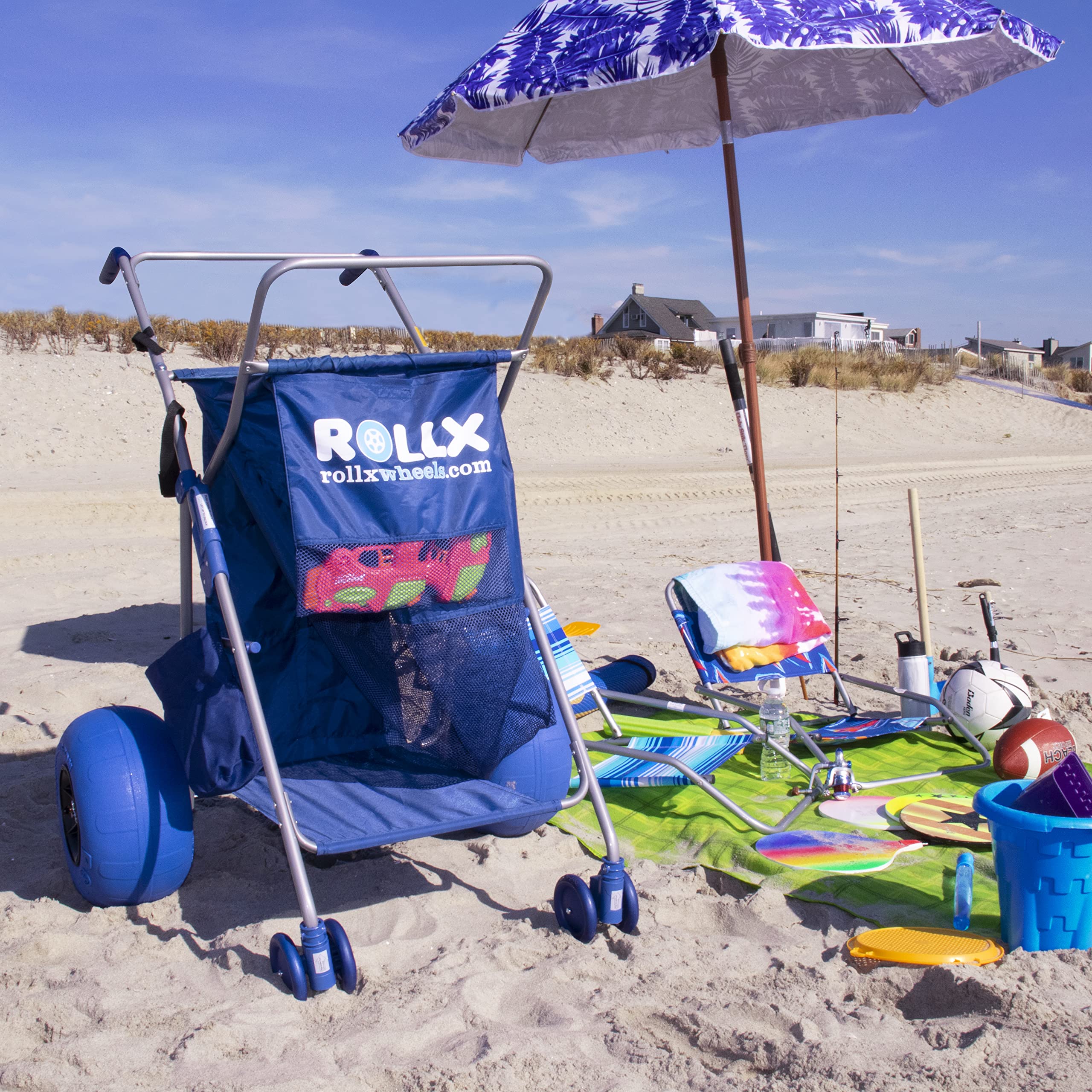 RollX cart in use on sandy beach carrying coolers and chairs — effortless hauling