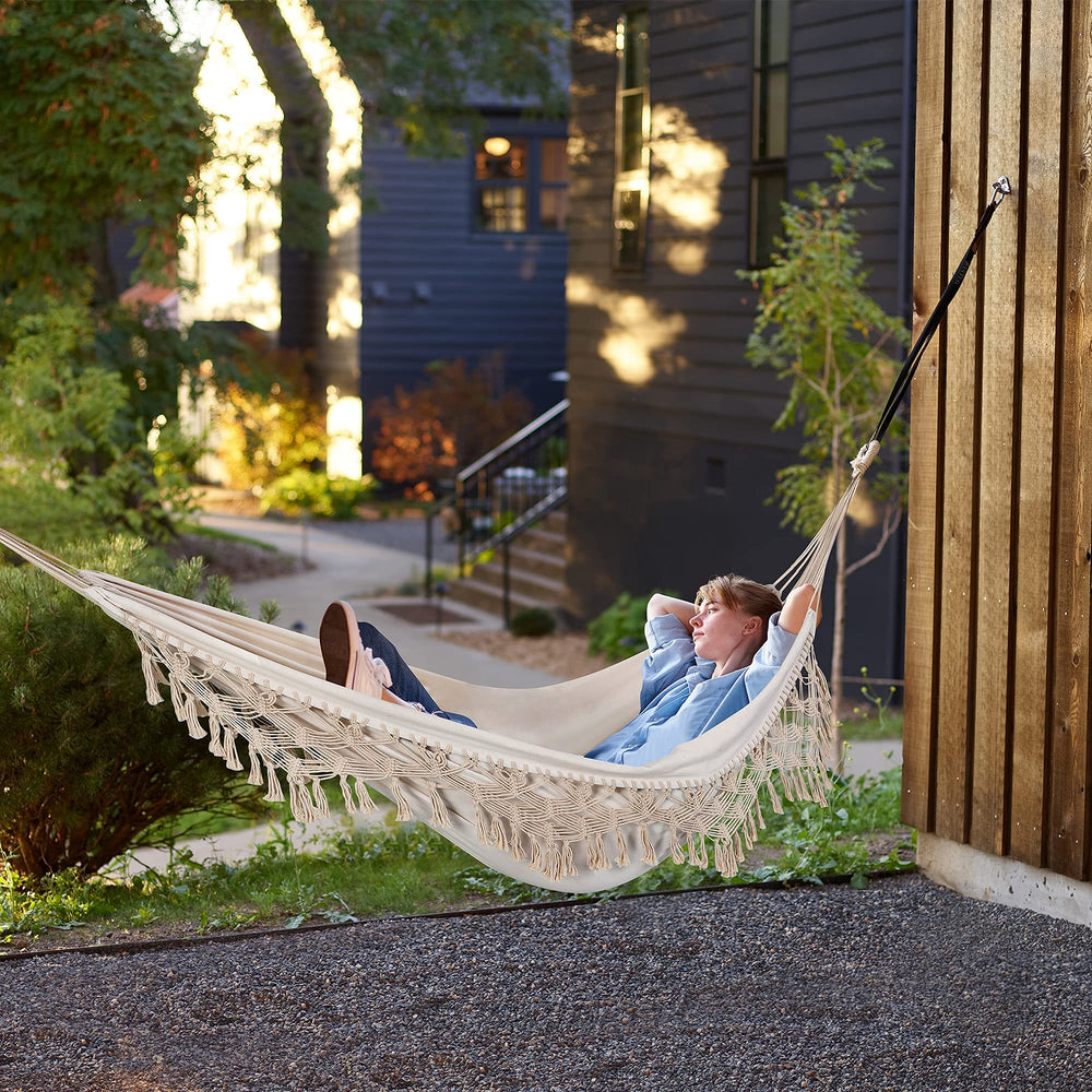 ROOITY hammock hanging from a tree outside highlighting camping-ready portability