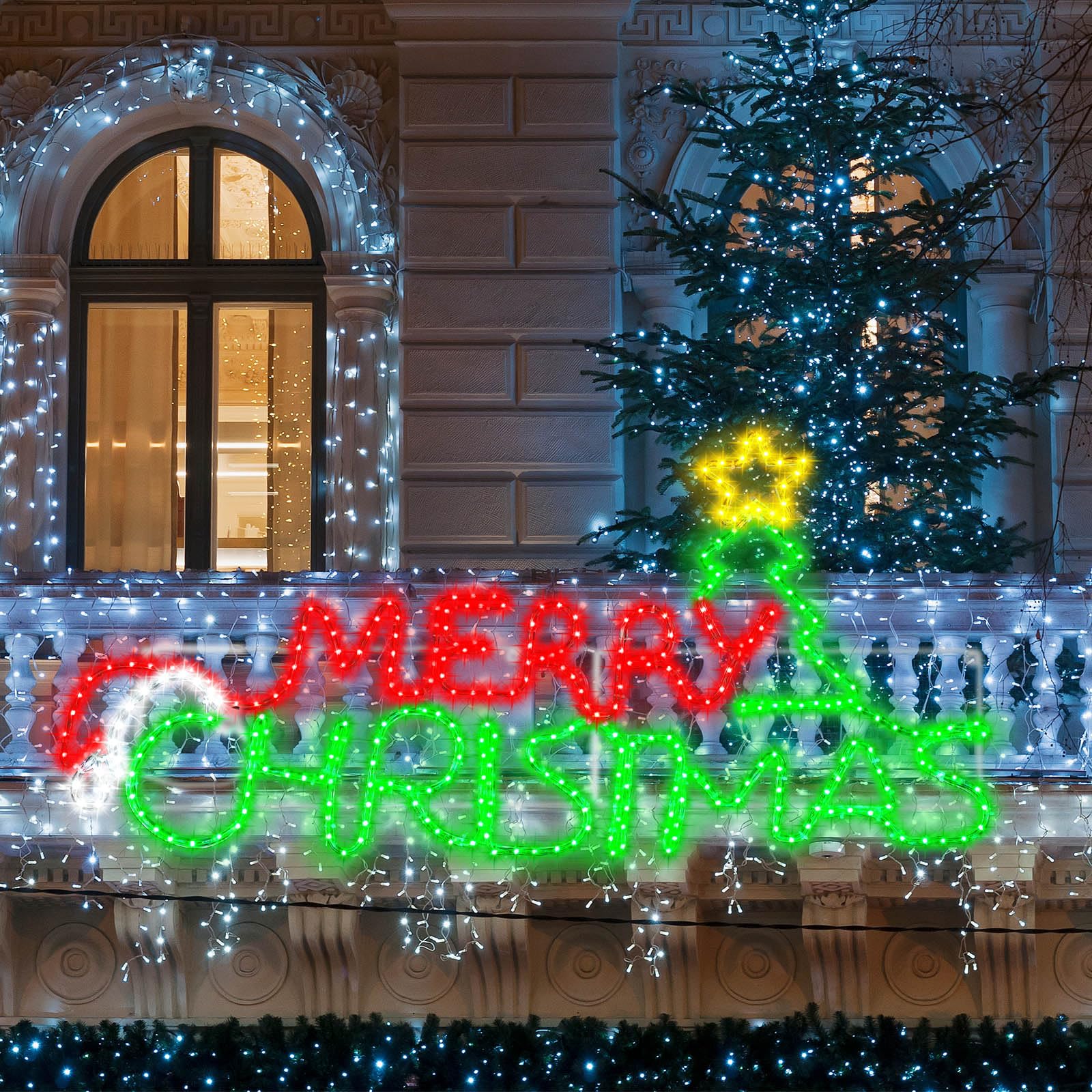 Rossesay front view of tree-style Merry Christmas sign showing festive glow and curb appeal