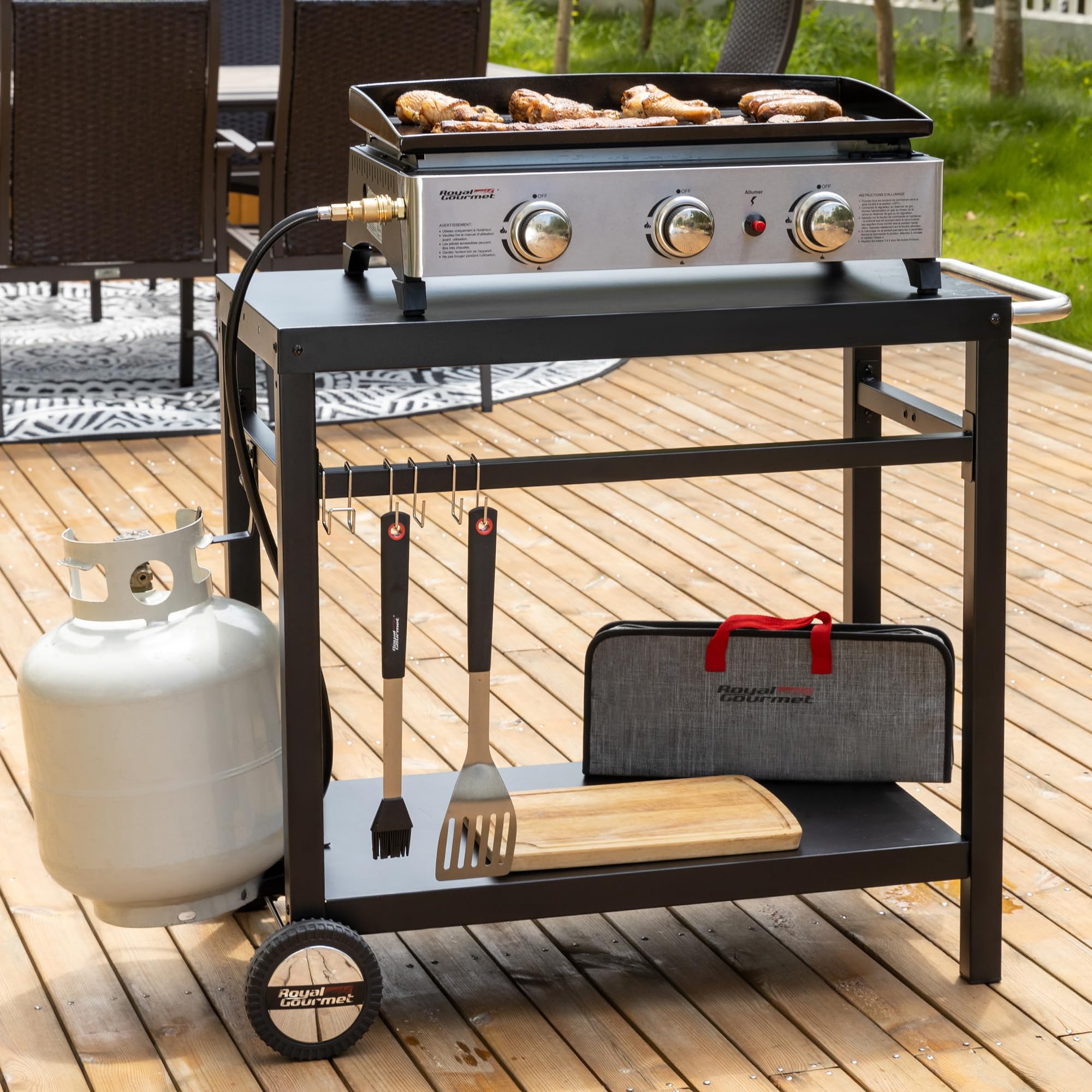 Royal Gourmet cart in backyard grilling scene offering a compact outdoor kitchen station
