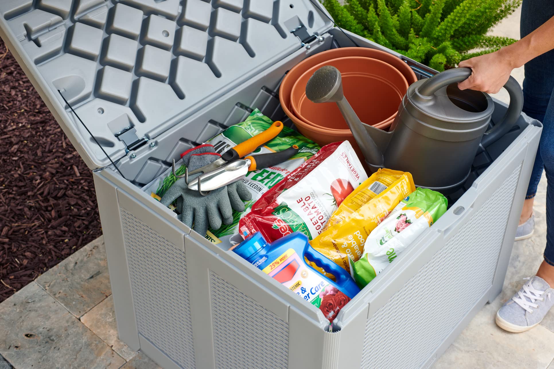 Rubbermaid deck box open lid revealing easy-access hinges and spacious interior for quick retrieval