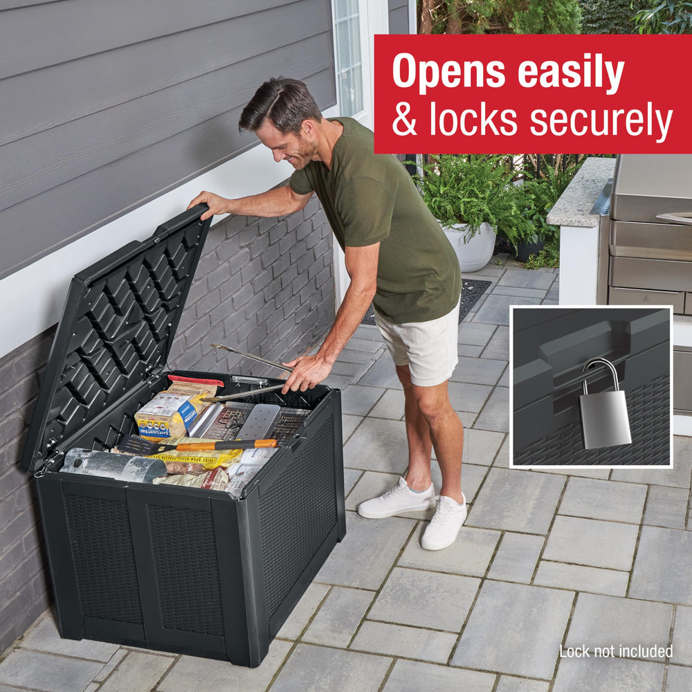 Rubbermaid deck box next to garden tools showing size and space-saving benefit