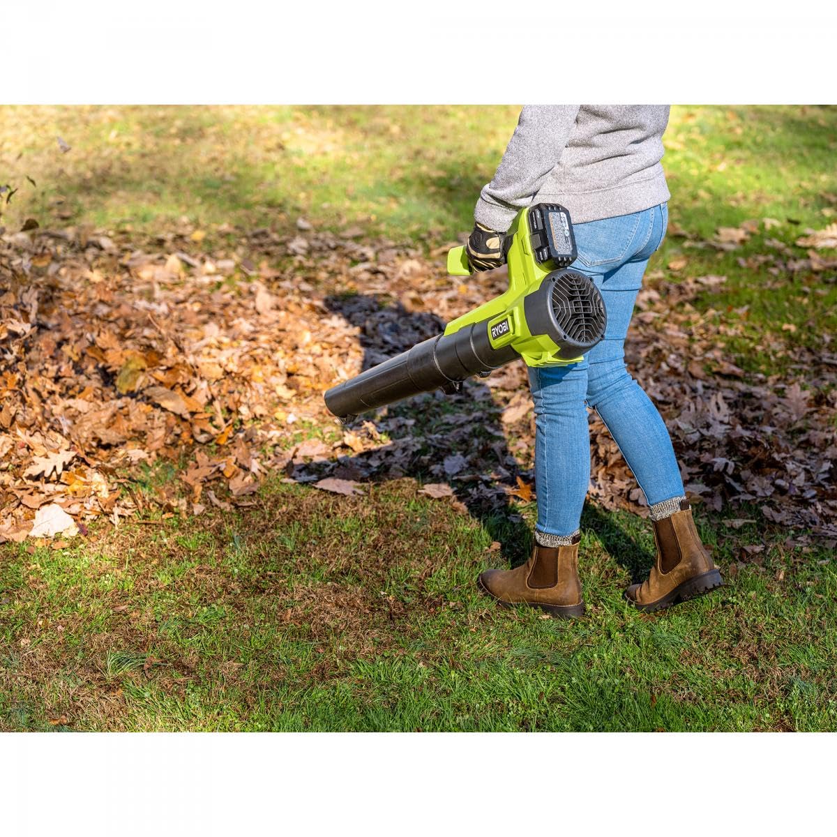 RYOBI blower beside a battery for scale showing compact storage benefit