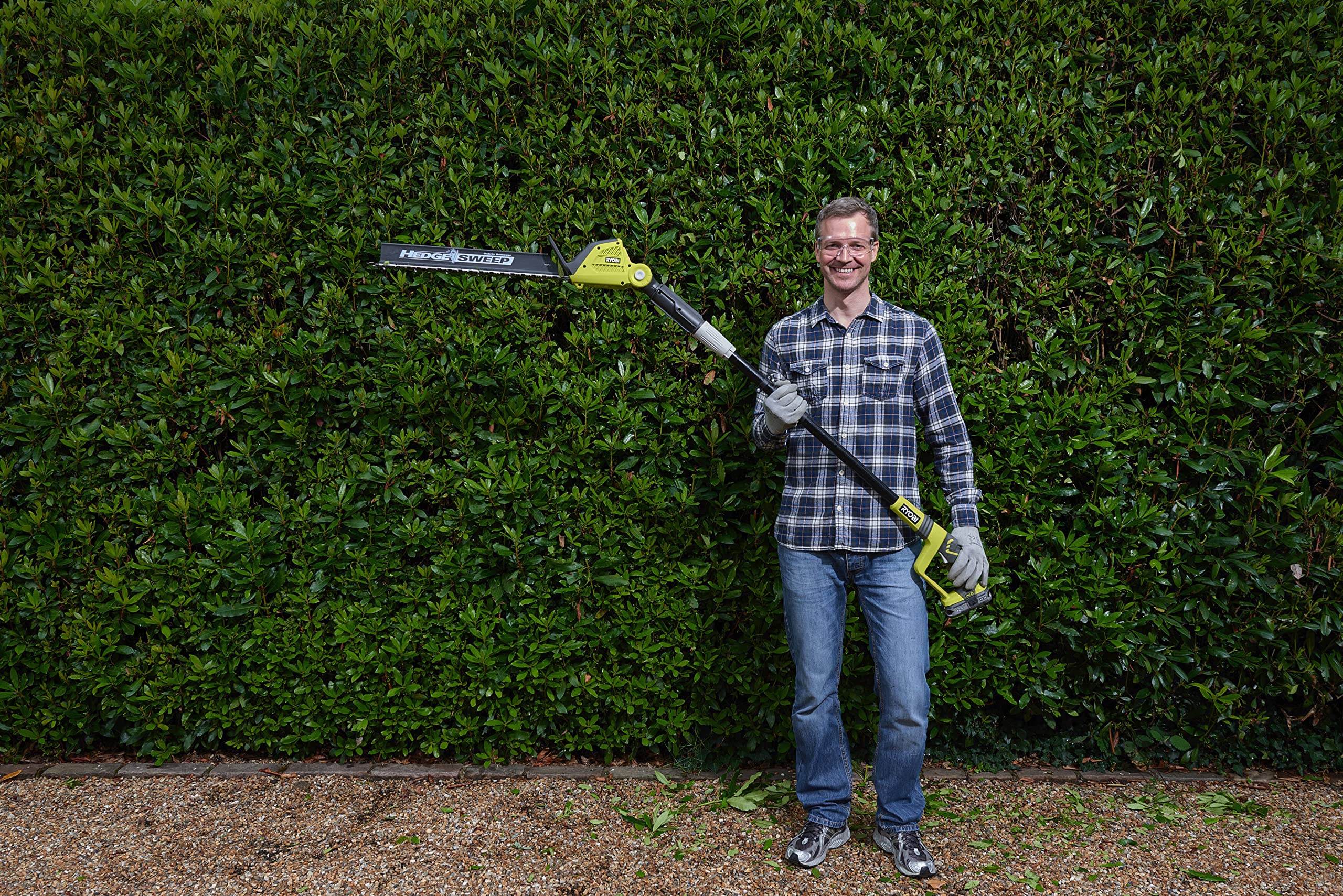 RYOBI full-length extended pole reaching high hedge for safe overhead trimming