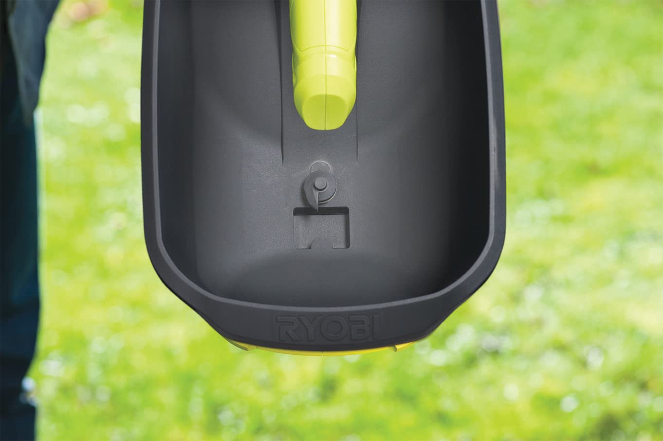 RYOBI OSS1800 controls and label close-up showing flow adjustment for precise spreading