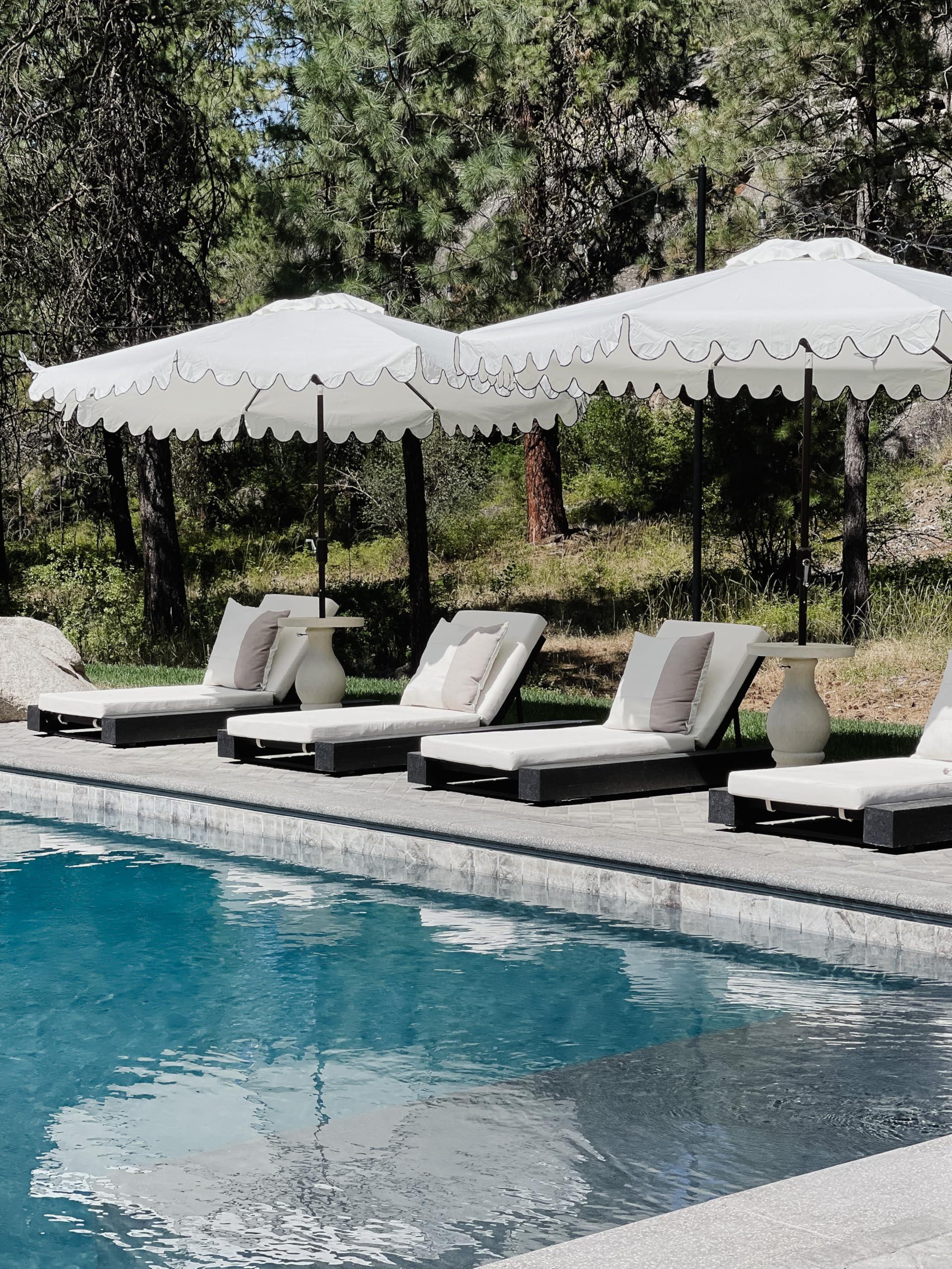SAFAVIEH umbrella in use over patio dining set providing cool shaded seating area