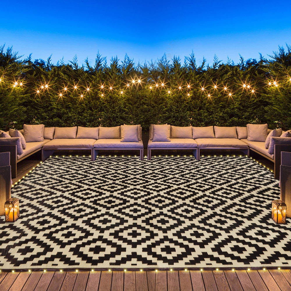 SAND MINE front view of reversible black and beige outdoor rug adds style