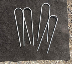 Sandbaggy staples securing drip tubing demonstrating firm hold