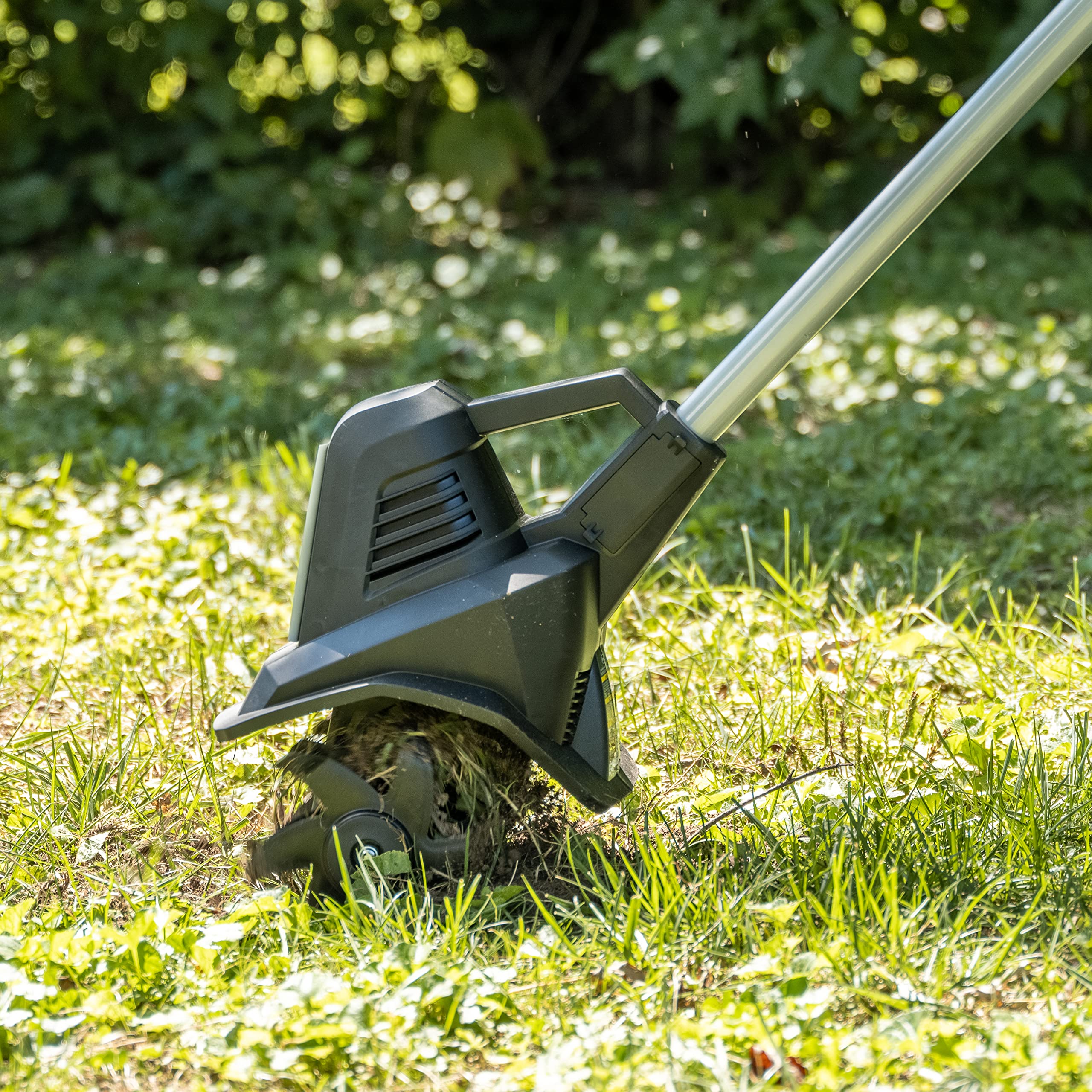 Scotts tiller edging a garden bed to remove weeds by the roots
