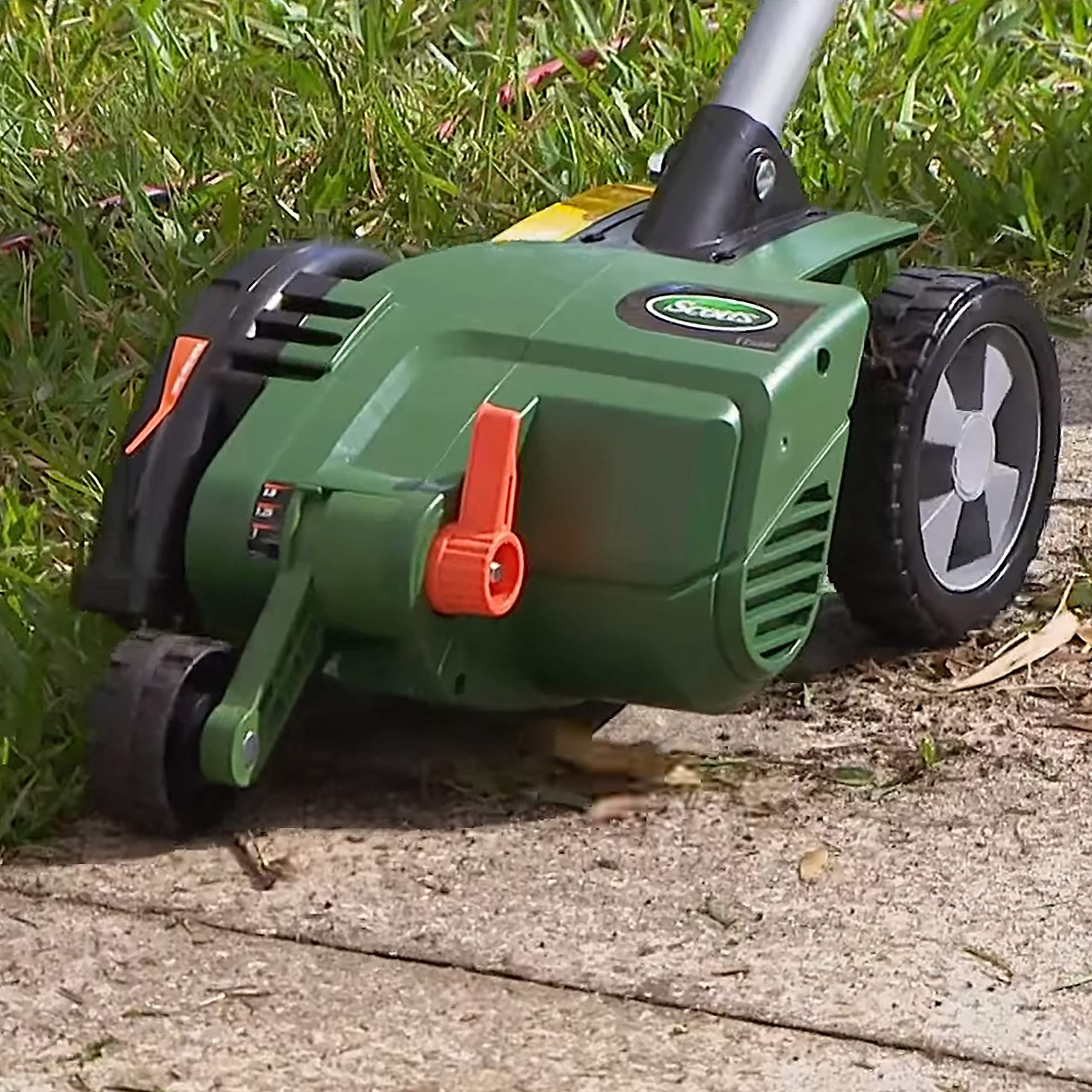 Scotts edger next to a foot for scale showing compact ergonomic size