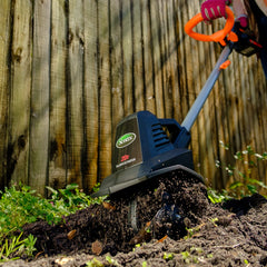 Scotts tiller in use in a raised bed mixing compost for healthier soil