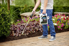 Scotts wand spraying mulch demonstrating effortless coverage and time-saving benefit