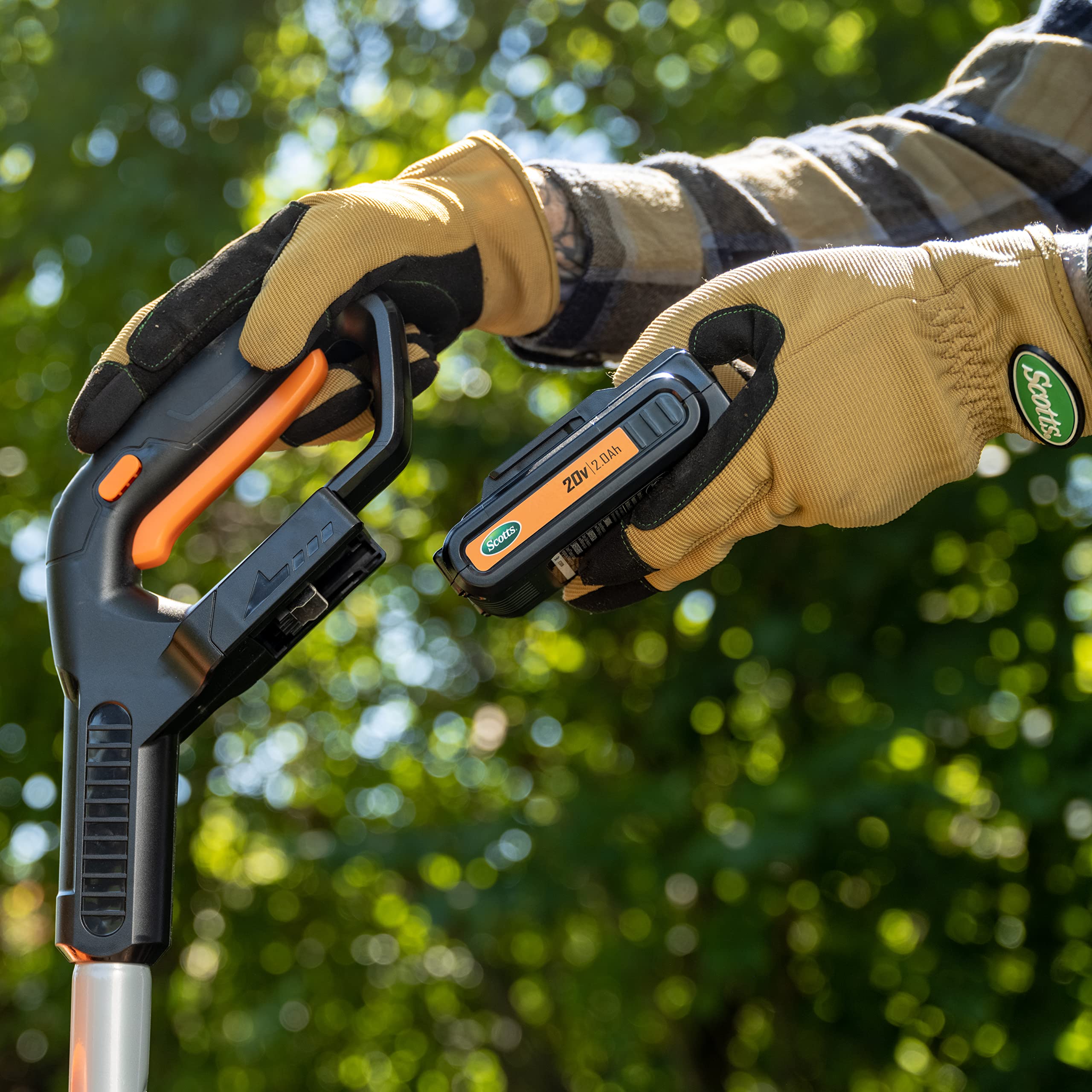 Scotts tiller next to a hand to show lightweight, portable scale