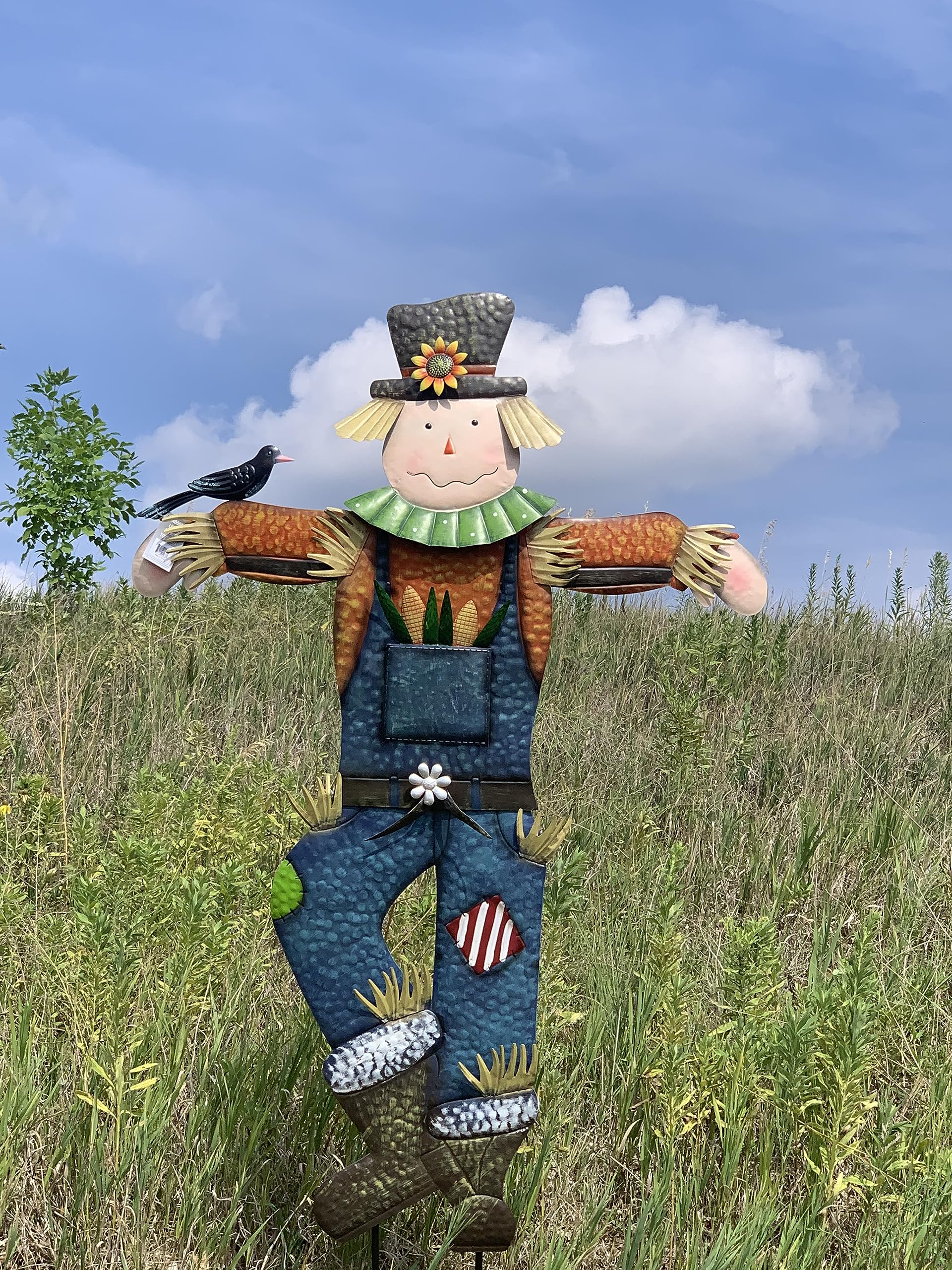 Seasonal Expressions scarecrow installed on lawn near porch providing seasonal focal point