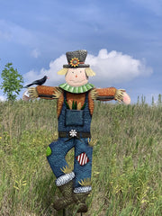 Seasonal Expressions scarecrow installed on lawn near porch providing seasonal focal point