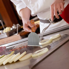 SHANGPEIXUAN scraper in use on griddle removing grease for quicker service