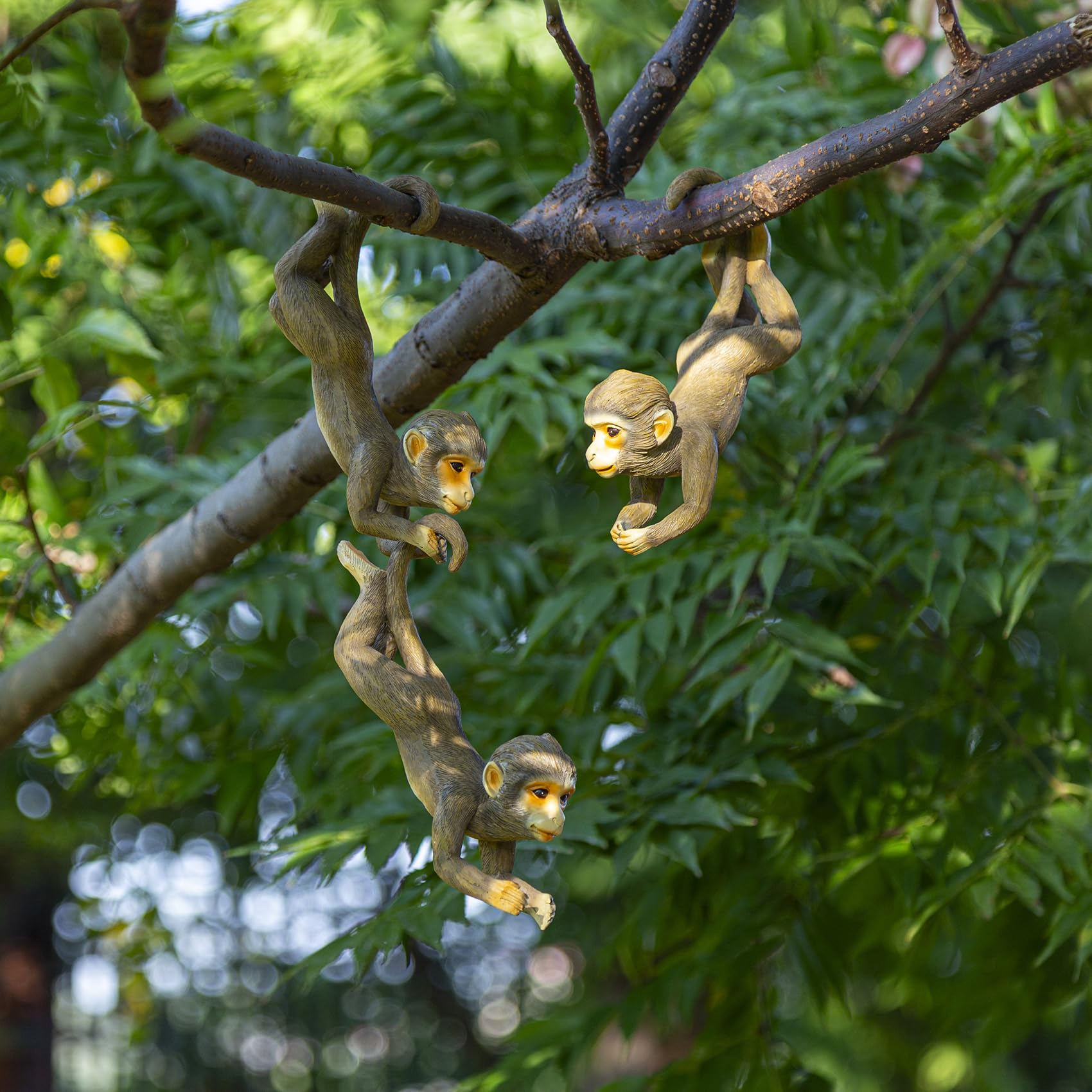SHAODIE front view of three hanging monkey sculptures showing playful design and easy installation