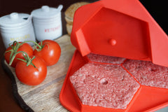 Shape+Store Burger Master MAX in use with frozen patties on barbecue demonstrating quick grill readiness