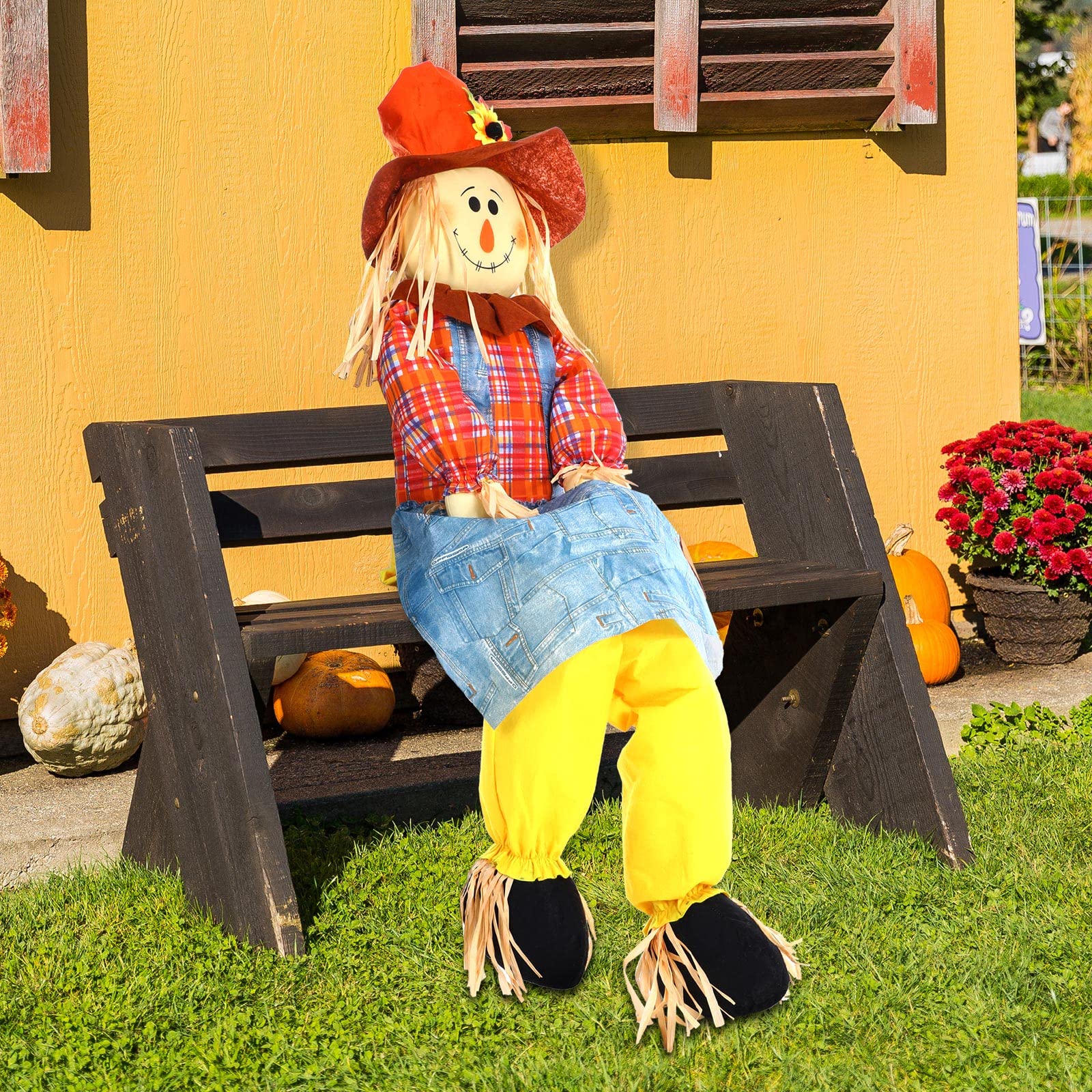 Shappy scarecrow seated on a porch chair showing how it props without extra support