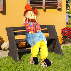 Shappy scarecrow seated on a porch chair showing how it props without extra support