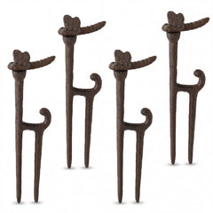 Shimeyao front view of four cast iron hose guide stakes showing rustic finish and dragonfly tops for decorative protection